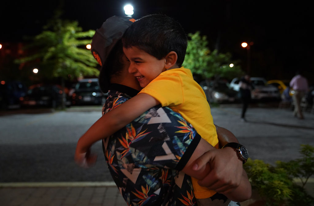 Mohamed Baqer Al Hraishawi, 4, jumps into his 15-year-old brother Hussein Al Hraishawi's arms